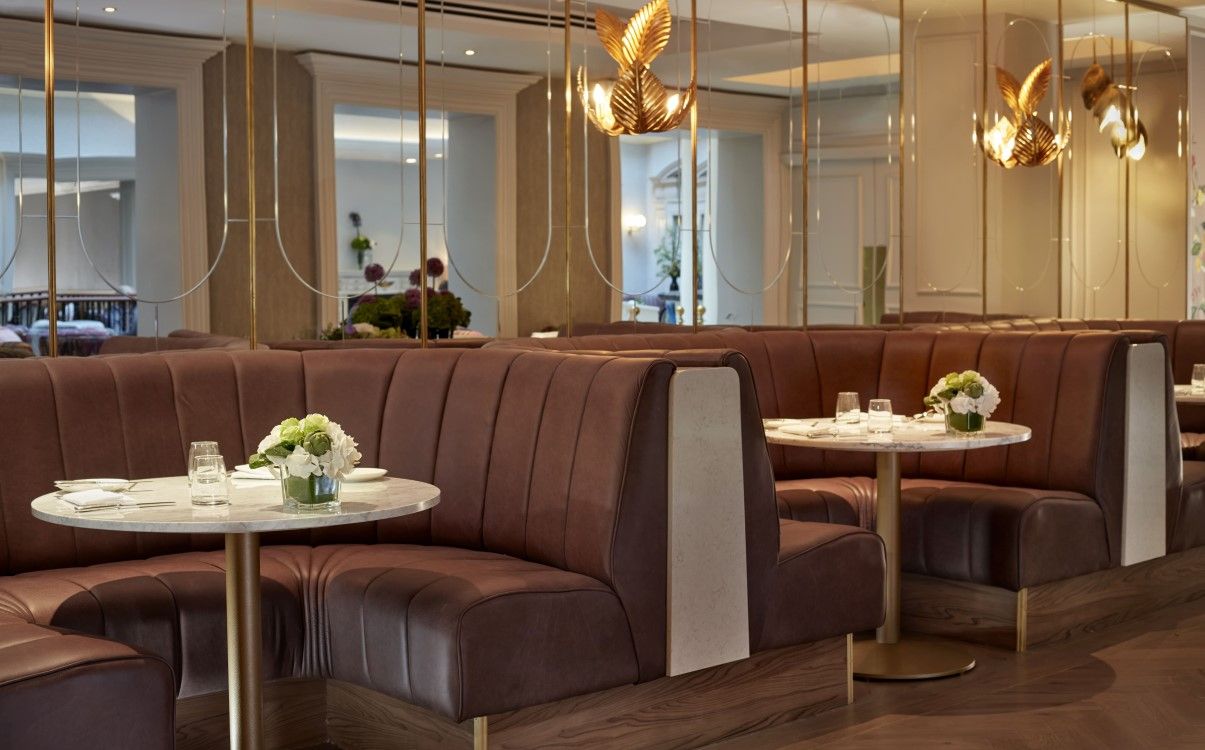 Two booths with flowers and crockery in The College Green Hotel Dublin