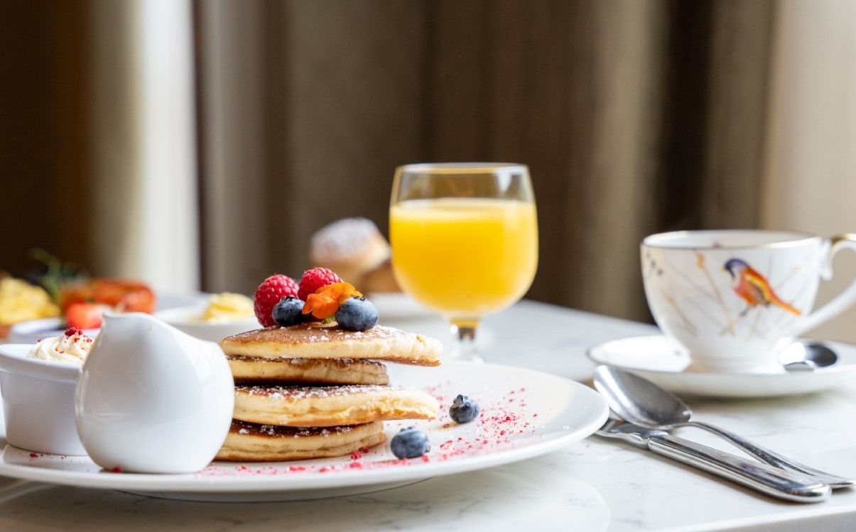 Pancake stack in Morelands Grill with orange juice and tea cup